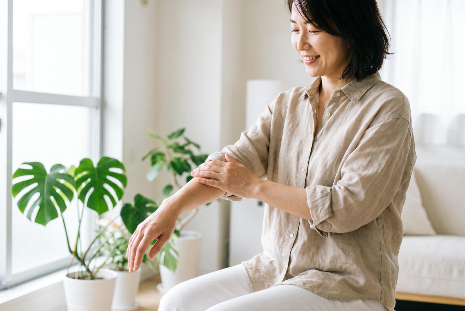 前腕をやさしくさすっている女性