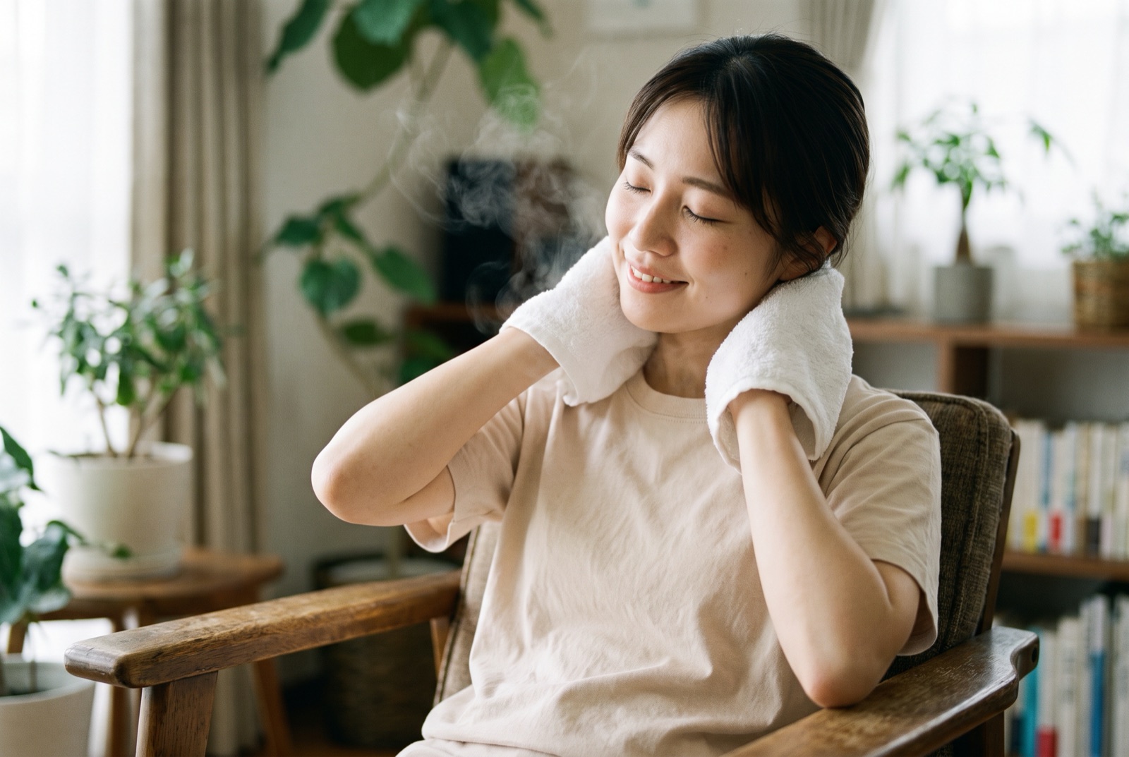 首の後ろに温かいタオルを当てて、椅子に座ってくつろいでいる女性